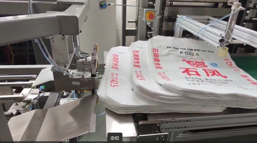 Bag grabbing mechanism valve bag inserter machine manufacturing plant cost